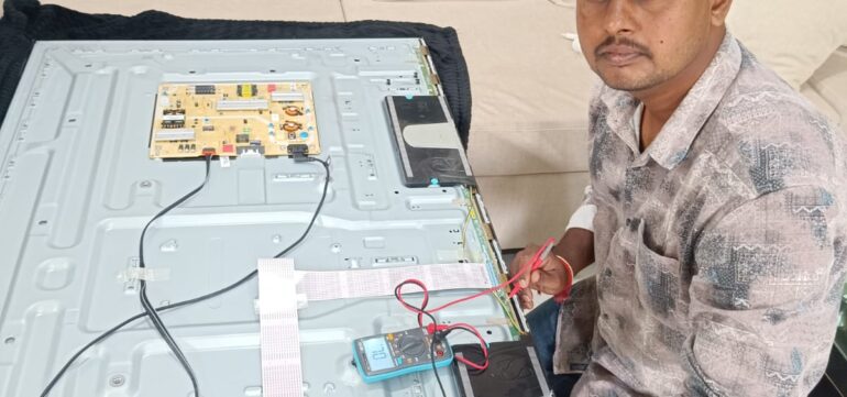 Technician performing TV screen replacement in Hyderabad at customer’s home.